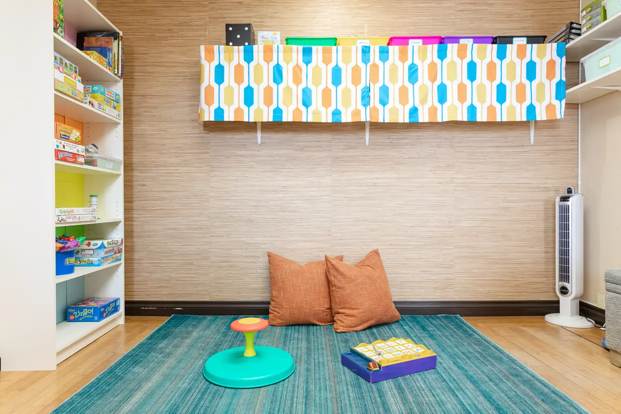 Therapy room at Ocean Beach Speech with cubbies, games, and colorful decor